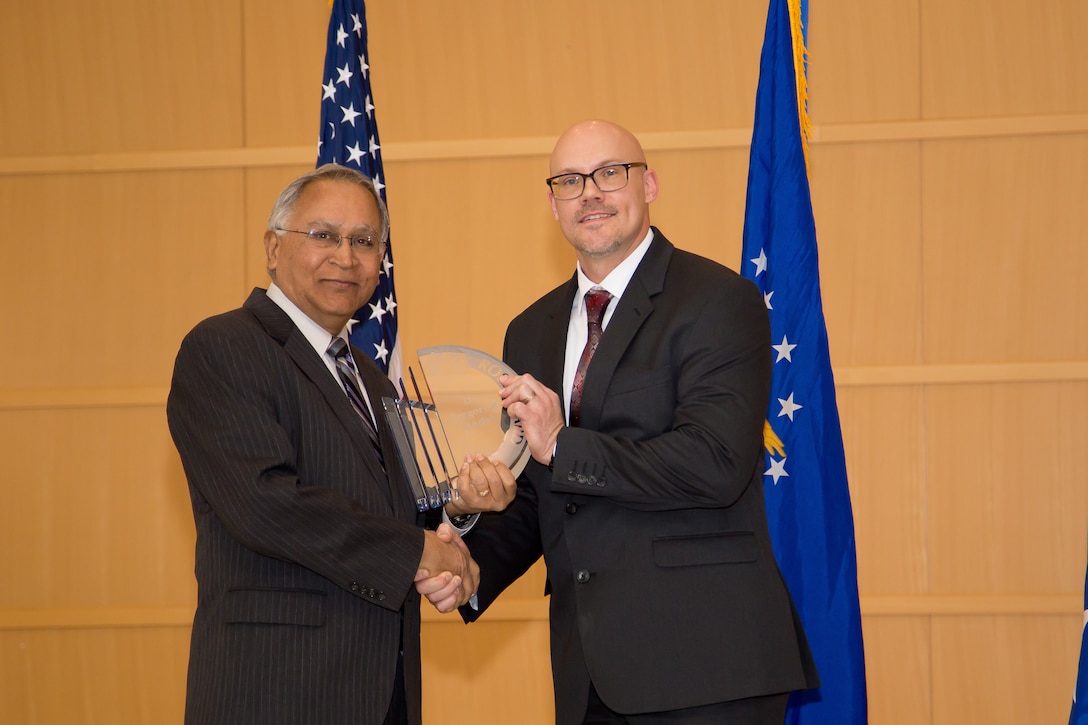 Dr. Gregory Yandek (right) from Edwards Air Force Base, California, was on hand to accept the Don Ross Award from Dr. Siva Banda (left), chief scientist, Aerospace System’s Directorate. This award recognizes a culmination, multi-year outstanding scientific or engineering achievement in space, science and technology. The directorate held their annual awards ceremony Jan. 24. (U.S. Air Force photo/Danielle DeBorde)