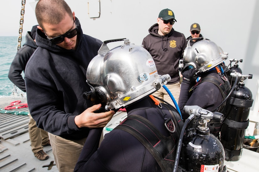 Army Sgt. Alex J. Fanning, left, a second class diver assigned to the 86th Engineer Dive Detachment, checks a diver’s equipment before conducting a dive near Kuwait Naval Base, Kuwait, Jan. 22, 2019. The Soldiers rehearse a variety of emergency procedures to ensure the safety of the divers.