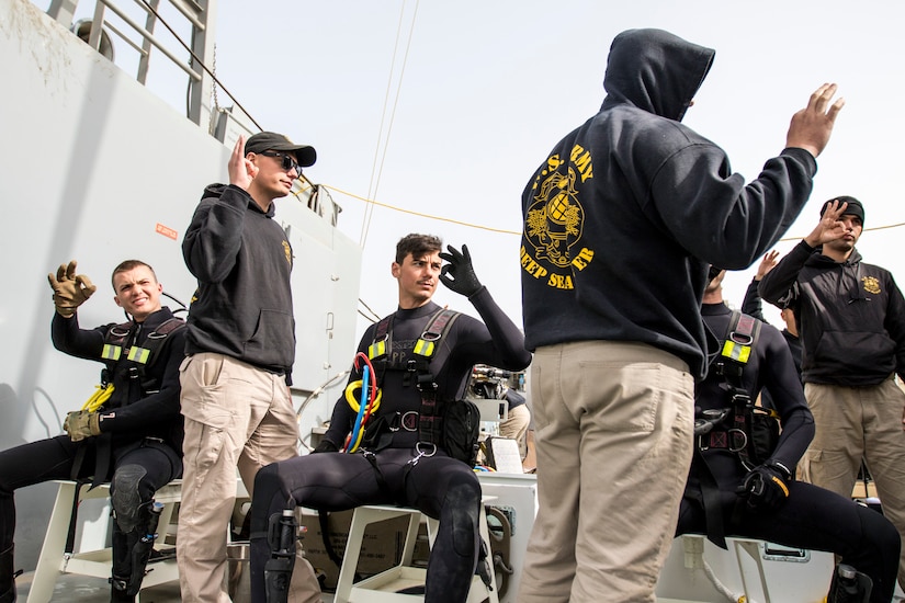 Soldiers assigned to the 86th Engineer Dive Detachment signal that they are prepared to perform their individual roles during dive supervisor training and qualification near Kuwait Naval Base, Kuwait, Jan. 22, 2019. The Soldiers operate as a team to ensure the divers accomplish their mission as safely as possible.