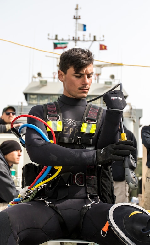 Army Pfc. Matthew M. Epperson, a second class diver assigned to the 86th Engineer Dive Detachment, checks his equipment before conducting a dive near Kuwait Naval Base, Kuwait, Jan. 22, 2019. The 86th EDD conducted dive supervisor training and qualification to increase the number of Soldiers qualified to act as dive supervisors as well as to increase their units overall readiness.