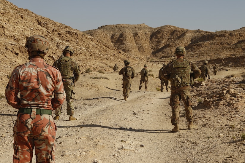 An Omani Soldier prepares to follow a squad of troops from 2nd Battalion, 198th Armored Regiment, 155th Armored Brigade Combat Team, Mississippi National Guard as they conduct squad movements through a wadi in Rabkoot, Oman, Jan. 28, 2019. ‘Wadi’ translates to ‘valley’ from Arabic to English. The U.S. Army and the Royal Army of Oman are spending days in a wadi system conducting team, squad, and platoon maneuvers during exercise Inferno Creek 19. The bilateral exercise was designed to strengthen relations between the two militaries. It is an opportunity for both militaries to build tactical proficiency and gain shared understanding of each other’s forces and support long-term regional stability.