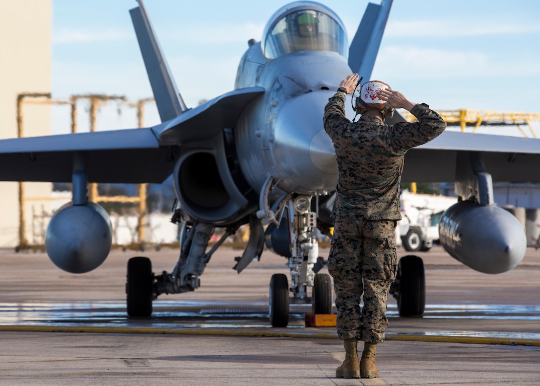 A Marine from Marine Fighter Attack Squadron (VMFA) 232, Marine Aircraft Group (MAG) 11, marshals an F/A-18C Hornet onto the flight line during a training exercise called the ‘Elephant Walk’ on Marine Corps Air Station Miramar, Calif., Feb. 1.   MAG-11 conducted this training to exercise its real-world capabilities. Exercises such as this provide realistic, relevant training necessary for 3rd MAW to “Fix, Fly, and Fight” as the Marine Corps’ largest aircraft wing and ensures the unit remains combat-ready, inter-operable, deployable on short notice, and lethal when called into action.  (U.S. Marine Corps photo by Cpl. Nadia J. Stark)