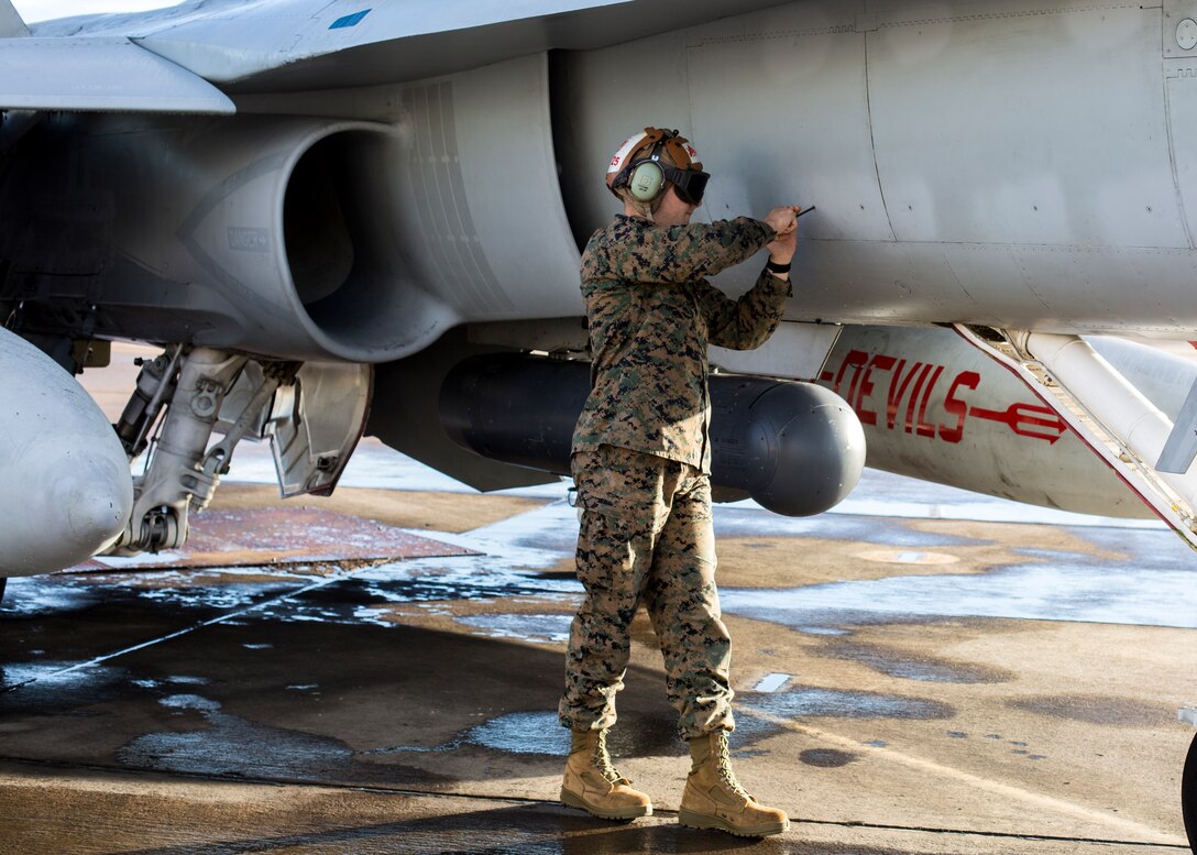 A Marine from Marine Fighter Attack Squadron (VMFA) 232, Marine Aircraft Group (MAG) 11 fastens panels on an F/A-18C Hornet prior to a training exercise on Marine Corps Air Station Miramar, Calif., Feb. 1.  MAG-11 conducted this training to exercise its real-world capabilities. Exercises such as this provide realistic, relevant training necessary for 3rd MAW to “Fix, Fly, and Fight” as the Marine Corps’ largest aircraft wing and ensures the unit remains combat-ready, inter-operable, deployable on short notice, and lethal when called into action. (U.S. Marine Corps photo by Cpl. Nadia J. Stark)