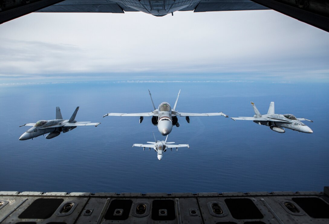 Four F/A-18C Hornets assigned to Marine Fighter Attack Squadron (VMFA) 323 fly in formation behind a KC-130J Super Hercules attached to Marine Aerial Refueler Transport Squadron (VMGR) 352, Marine Aircraft Group (MAG) 11, during a readiness exercise called the ‘Elephant Walk’ above Marine Corps Air Station Miramar, Calif., Feb. 1.  MAG-11 conducted this training to exercise its real-world capabilities. Exercises such as this provide realistic, relevant training necessary for 3rd MAW to “Fix, Fly, and Fight” as the Marine Corps’ largest aircraft wing and ensures the unit remains combat-ready, inter-operable, deployable on short notice, and lethal when called into action. (U.S. Marine Corps photo by Cpl. Becky Cleveland)