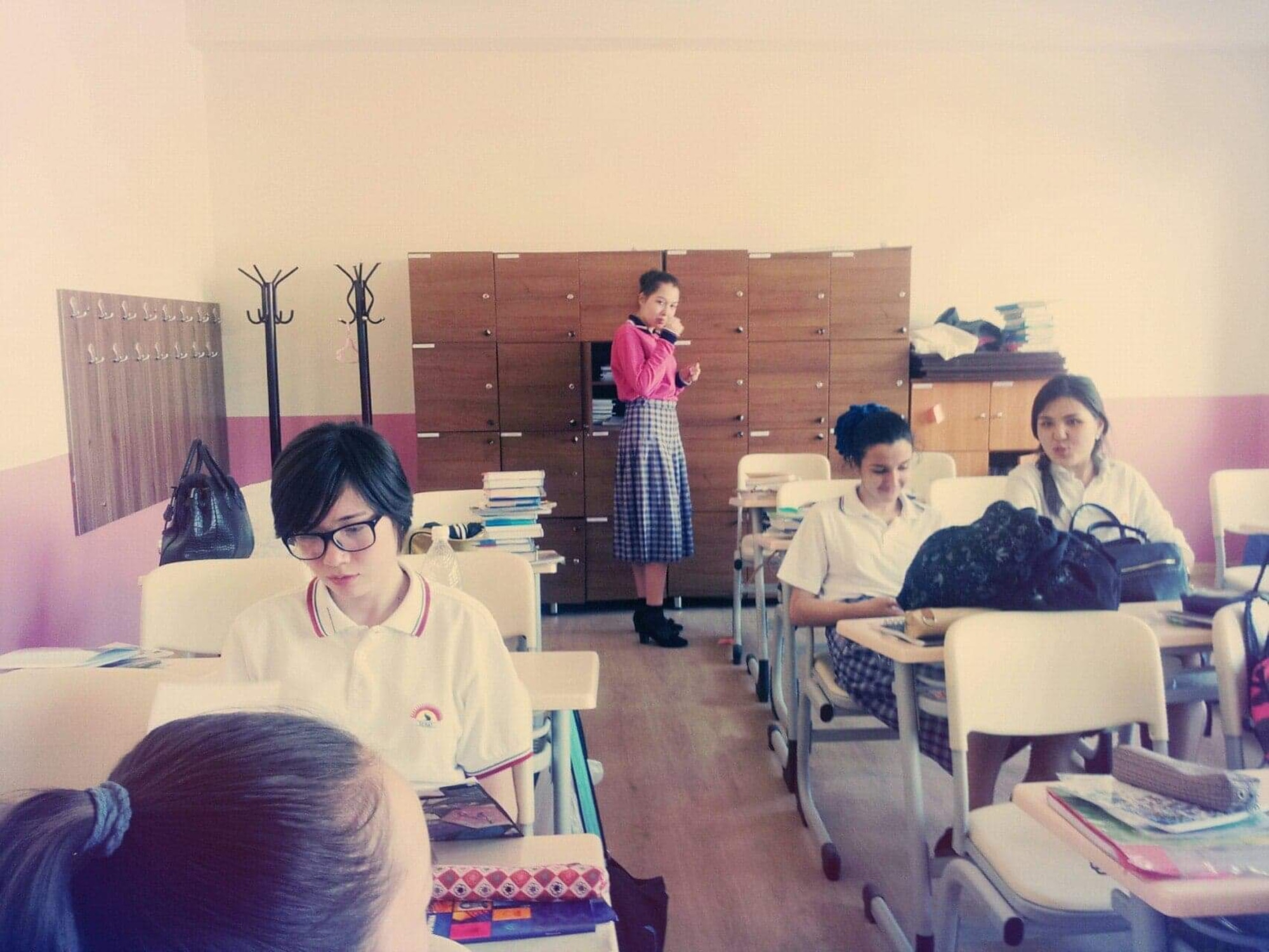 A photo of Airman 1st Class Vera Schwenk, an avionics technician assigned to the 509th Maintenance Squadron, standing in her boarding school classroom in Kyrgyzstan as a teenager.