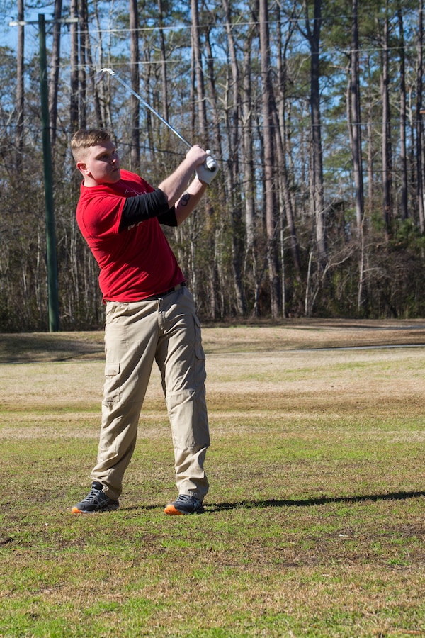U.S Marine Corps Sgt. Emmit Jakes hits a golf ball during the Headquarters and Headquarters Squadron (H&HS) Polar Bear Superball Tournament at Marine Corps Air Station Cherry Point, North Carolina, Jan. 25, 2019. The golf tournament was held to raise donations for the squadrons’ 2019 Marine Corps Birthday Ball. Each team consisted of four golfers, with prizes being awarded to the first, second and third place teams. The first place team won a $35 gift card per golfer to use at the Sound of Freedom Golf Course shop at MCAS Cherry Point and the second place team won a free round of golf at the course per golfer. (U.S. Marine Corps photo by Lance Cpl. Andrew King)