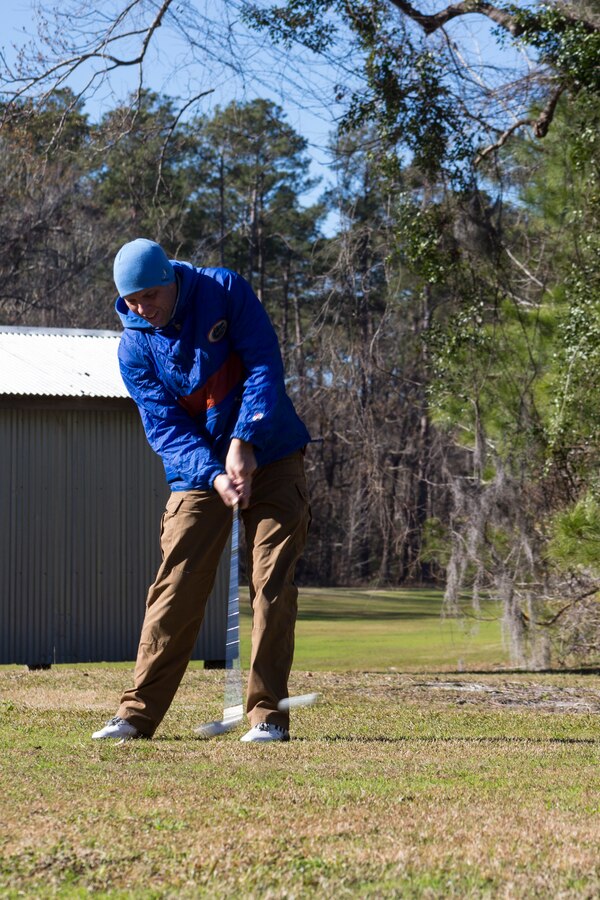 U.S Marine Corps Maj. Brian Taylor tees off during the Headquarters and Headquarters Squadron (H&HS) Polar Bear Superball Tournament at Marine Corps Air Station Cherry Point, North Carolina, Jan. 25, 2019. The golf tournament was held to raise donations for the squadrons’ 2019 Marine Corps Birthday Ball. Each team consisted of four golfers, with prizes being awarded to the first, second and third place teams. The first place team won a $35 gift card per golfer to use at the Sound of Freedom Golf Course shop at MCAS Cherry Point and the second place team won a free round of golf at the course per golfer. (U.S. Marine Corps photo by Lance Cpl. Andrew King)