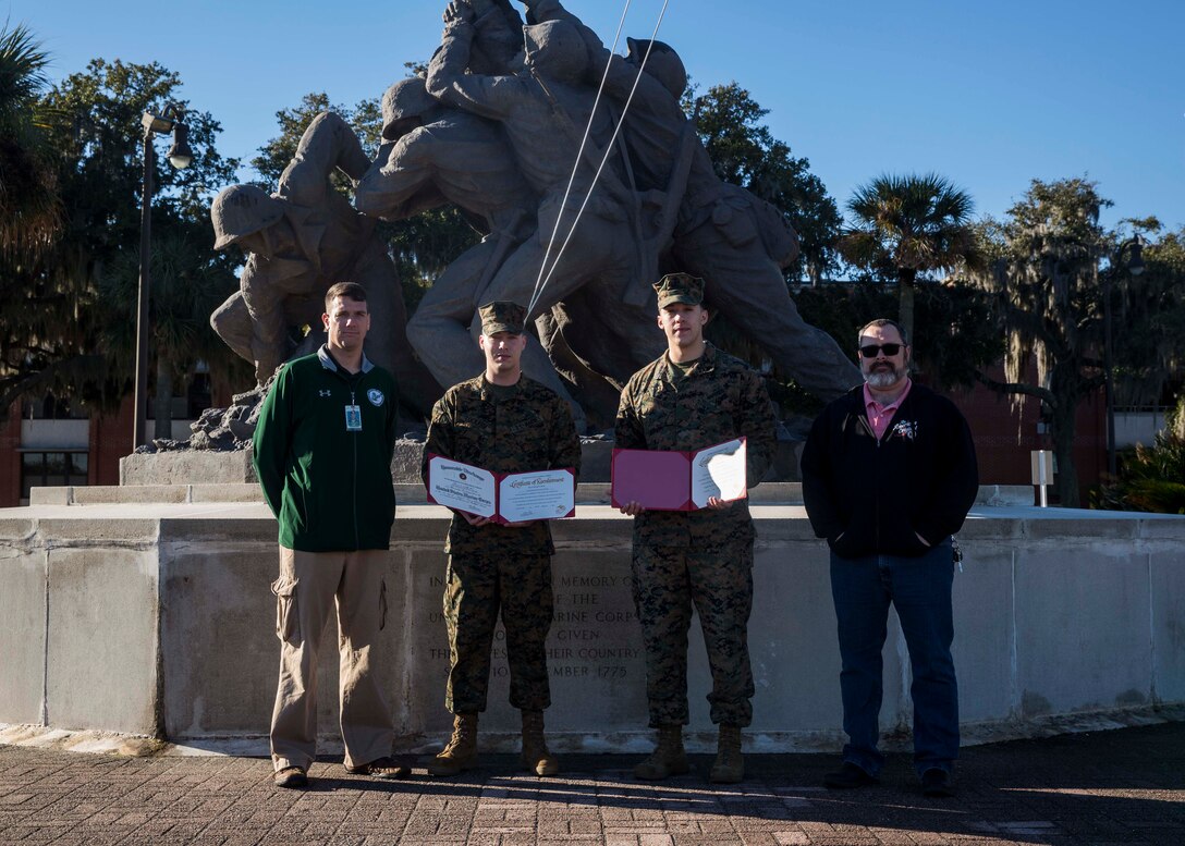 U.S. Marine Corps Staff Sgt. Trai Lockard, a data staff non-commissioned officer with 6th Marine Corps District, and Cpl. Christian Dominguez, a data non-commissioned officer with 6th MCD, pose for a photo after their reenlistment ceremony aboard Marine Corps Recruit Depot Parris Island, South Carolina, Feb. 4, 2019. Dominguez, a native of Allenton, Michigan, has currently served four years in the Marine Corps. Lockard, a native of Statesville, North Carolina, has currently served seven Years in the Marine Corps. (U.S. Marine Corps photo by Lance Cpl. Jack A. E. Rigsby)