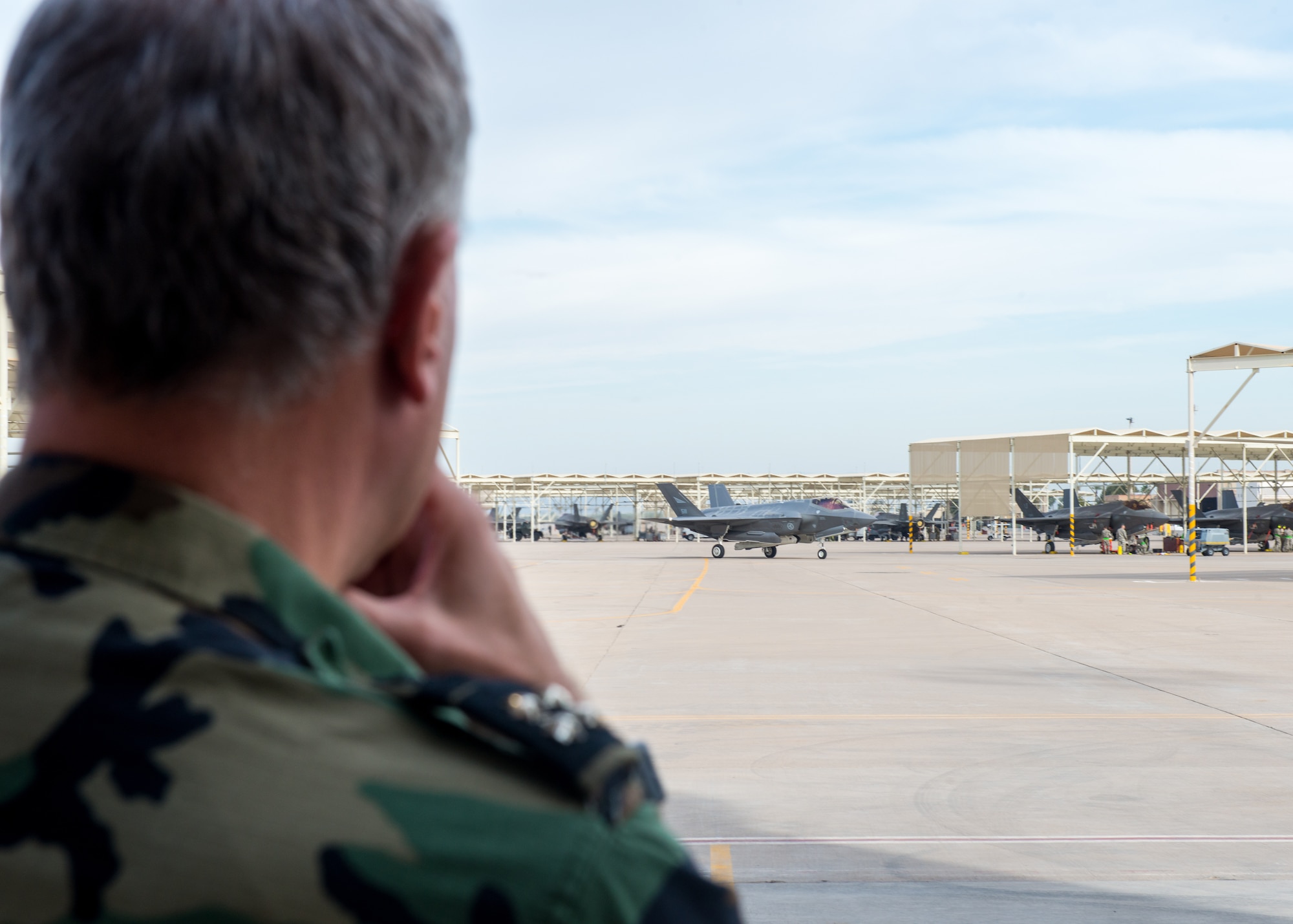 Netherlands Chief of Defense, Lieutenant Admiral Rob Bauer, observes an F-35A Lightning II taxing at Luke Air Force Base Ariz. Jan 30, 2019. The Netherlands is one of 10 nations that trains alongside US pilots in the F-16 and F-35 at Luke AFB. (U.S Air Force photo by Airman 1st Class Jacob Wongwai)