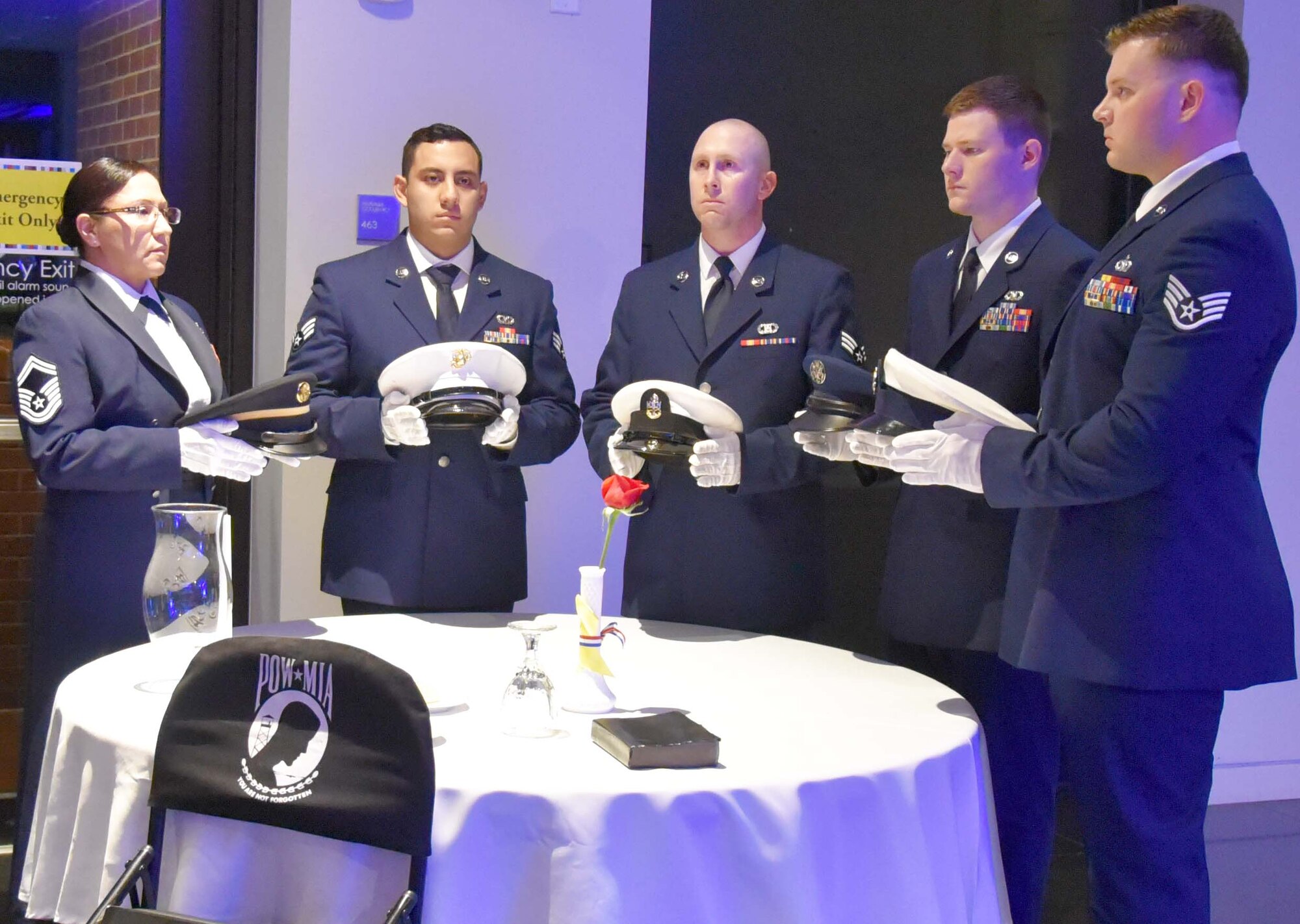 Citizen Reserve Airmen set the prisoners of war/missing in action table during the 2019 Annual Awards Banquet at the Wichita Art Museum, Feb. 2, 2019.  The tradition of setting a separate table in honor of prisoners of war and missing comrades has been in place since the end of the Vietnam War.