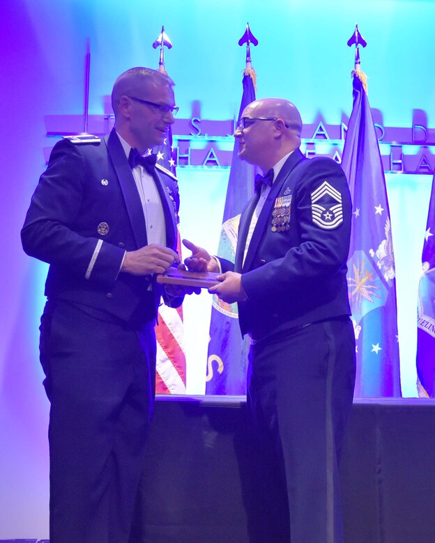 Col. Phil Heseltine, 931st Air Refueling Wing commander, presents Chief Master Sgt. Seth Thomas, 931 ARW acting command chief, with a gift at the 2019 Annual Awards Banquet at the Wichita Art Museum, Feb. 2, 2019.  The gift was to thank Thomas for his work the past few months as the acting command chief for the 931 ARW.