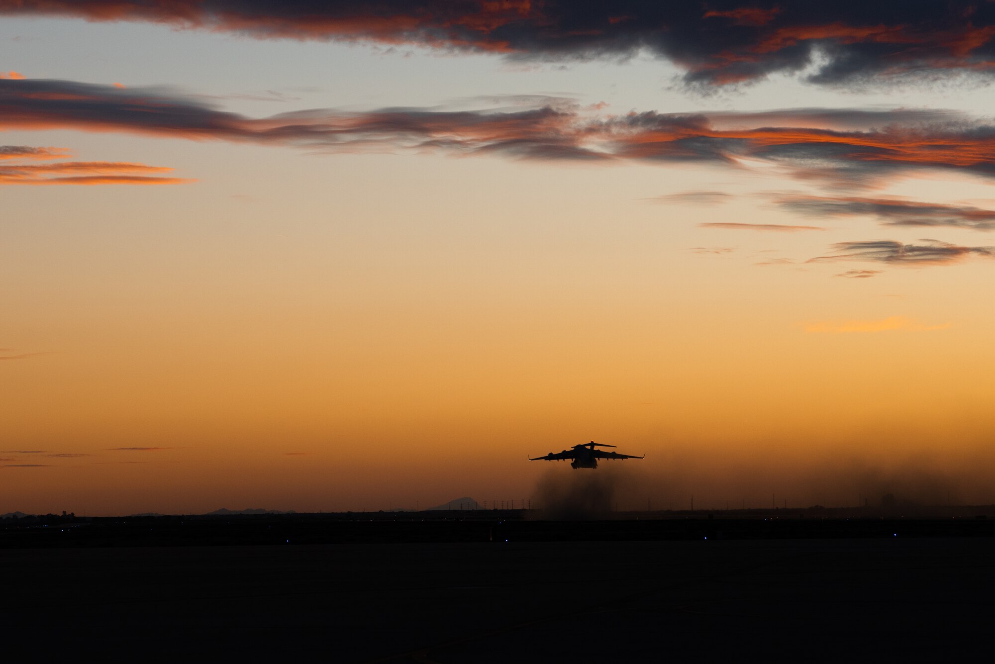 A C-17 Globemaster III takes off for Mountain Home Air Force Base, Idaho at dusk, Jan. 31, 2018 at Luke Air Force Base, Ariz.