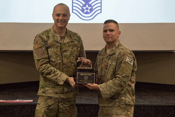 Col. Robert I. Kinney, 188th Wing commander, presents Master Sgt. Derek A. Nietert, the 188th Wing Outstanding Senior NCO of the Year, with a trophy at a commander’s call held at Ebbing Air National Guard Base, Ark., Jan. 13, 2019. (U.S. Air National Guard photo by Tech. Sgt. John E. Hillier)