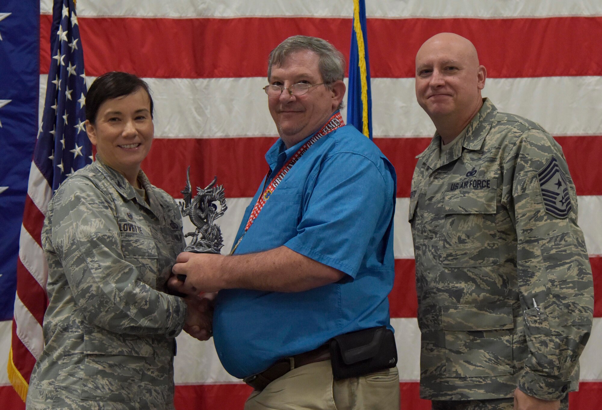 U.S. Air Force Col. Debra Lovette, 81st Training Wing commander, and Chief Master Sgt. David Pizzuto, 81st TRW command chief, present Len Van Sittert, 81st Medical Support Squadron medical contract manager, with the Civilian of the Year award, Supervisory Category II, during the 81st Training Wing's 2018 Annual Awards Ceremony inside a hangar at Keesler Air Force Base, Mississippi, Feb. 1, 2019. During the ceremony, base leadership recognized outstanding Airmen and civilians from across the installation for their accomplishments throughout 2018. (U.S. Air Force photo by Kemberly Groue)