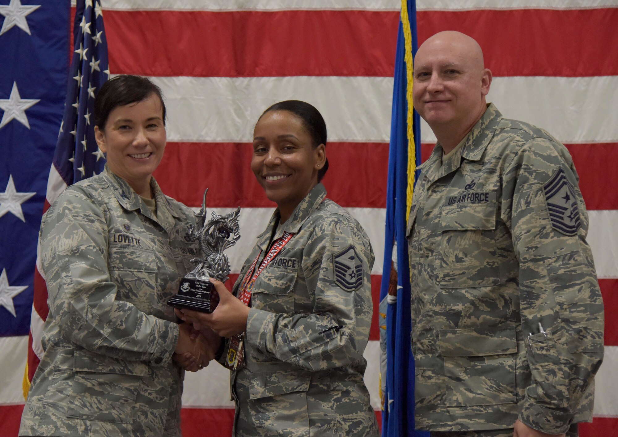 U.S. Air Force Col. Debra Lovette, 81st Training Wing commander, and Chief Master Sgt. David Pizzuto, 81st TRW command chief, present Master Sgt. Sharita Williams, 81st Medical Support Squadron first sergeant, with the First Sergeant of the Year award during the 81st Training Wing's 2018 Annual Awards Ceremony inside a hangar at Keesler Air Force Base, Mississippi, Feb. 1, 2019. During the ceremony, base leadership recognized outstanding Airmen and civilians from across the installation for their accomplishments throughout 2018. (U.S. Air Force photo by Kemberly Groue)