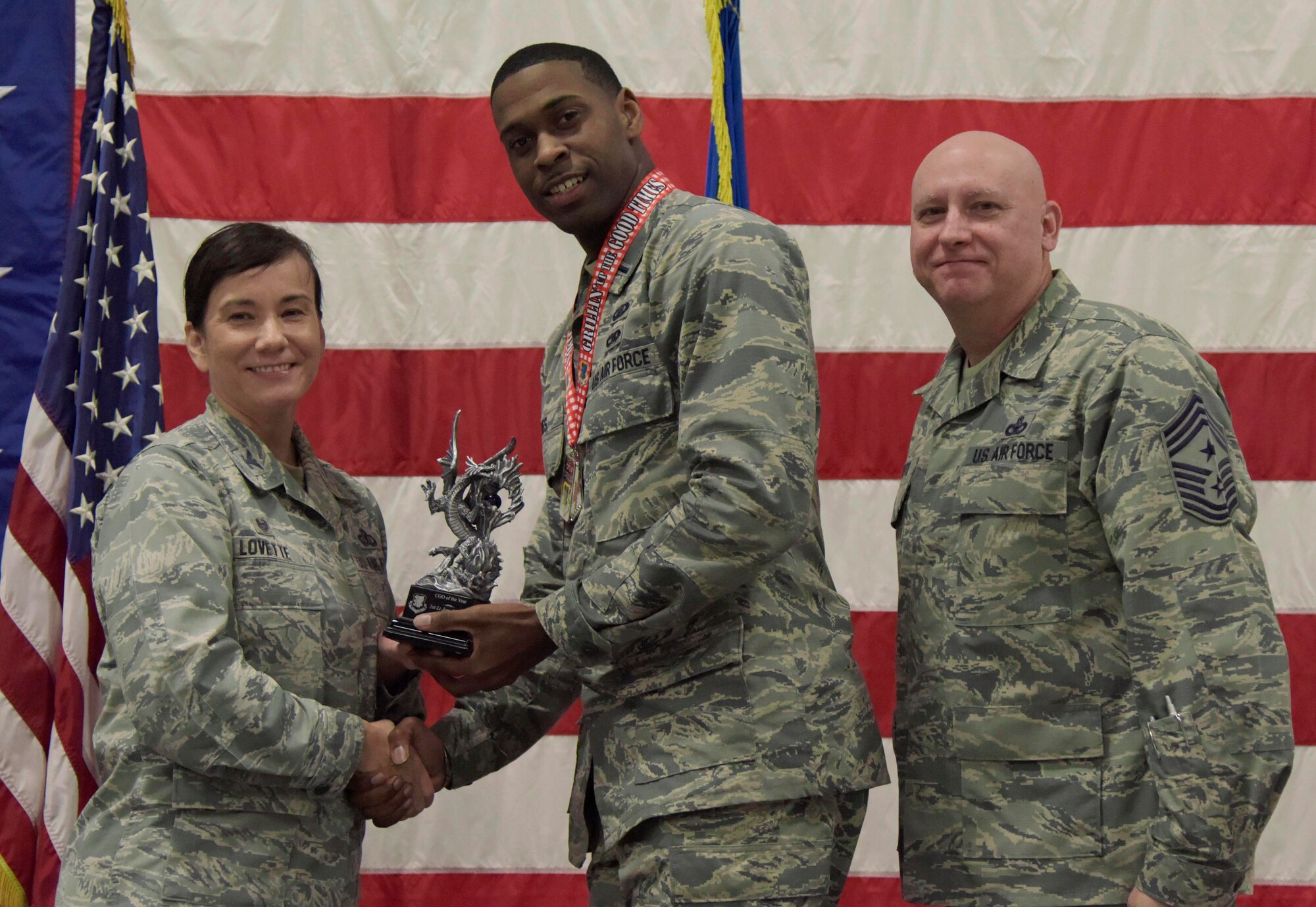 U.S. Air Force Col. Debra Lovette, 81st Training Wing commander, and Chief Master Sgt. David Pizzuto, 81st TRW command chief, present 1st Lt. Jared Hines, 81st Contracting Squadron contract specialist, with the Company Grade Officer of the Year award during the 81st Training Wing's 2018 Annual Awards Ceremony inside a hangar at Keesler Air Force Base, Mississippi, Feb. 1, 2019. During the ceremony, base leadership recognized outstanding Airmen and civilians from across the installation for their accomplishments throughout 2018. (U.S. Air Force photo by Kemberly Groue)