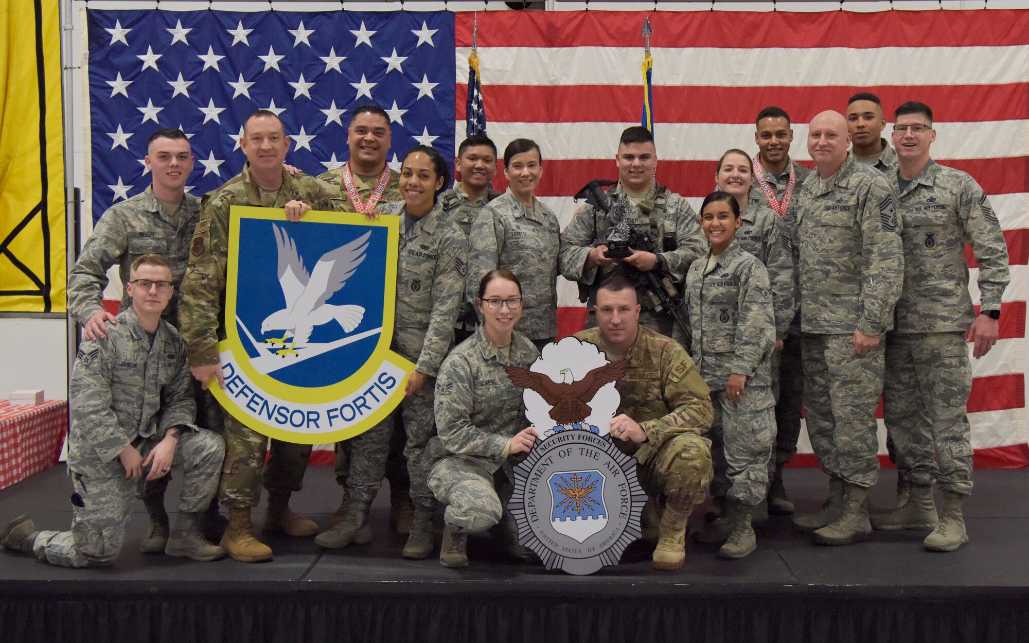U.S. Air Force Col. Debra Lovette, 81st Training Wing commander, and Chief Master Sgt. David Pizzuto, 81st TRW command chief, present members of the 81st Security Forces Squadron S3 Operations with the Team of the Year award during the 81st Training Wing's 2018 Annual Awards Ceremony inside a hangar at Keesler Air Force Base, Mississippi, Feb. 1, 2019. During the ceremony, base leadership recognized outstanding Airmen and civilians from across the installation for their accomplishments throughout 2018. (U.S. Air Force photo by Kemberly Groue)