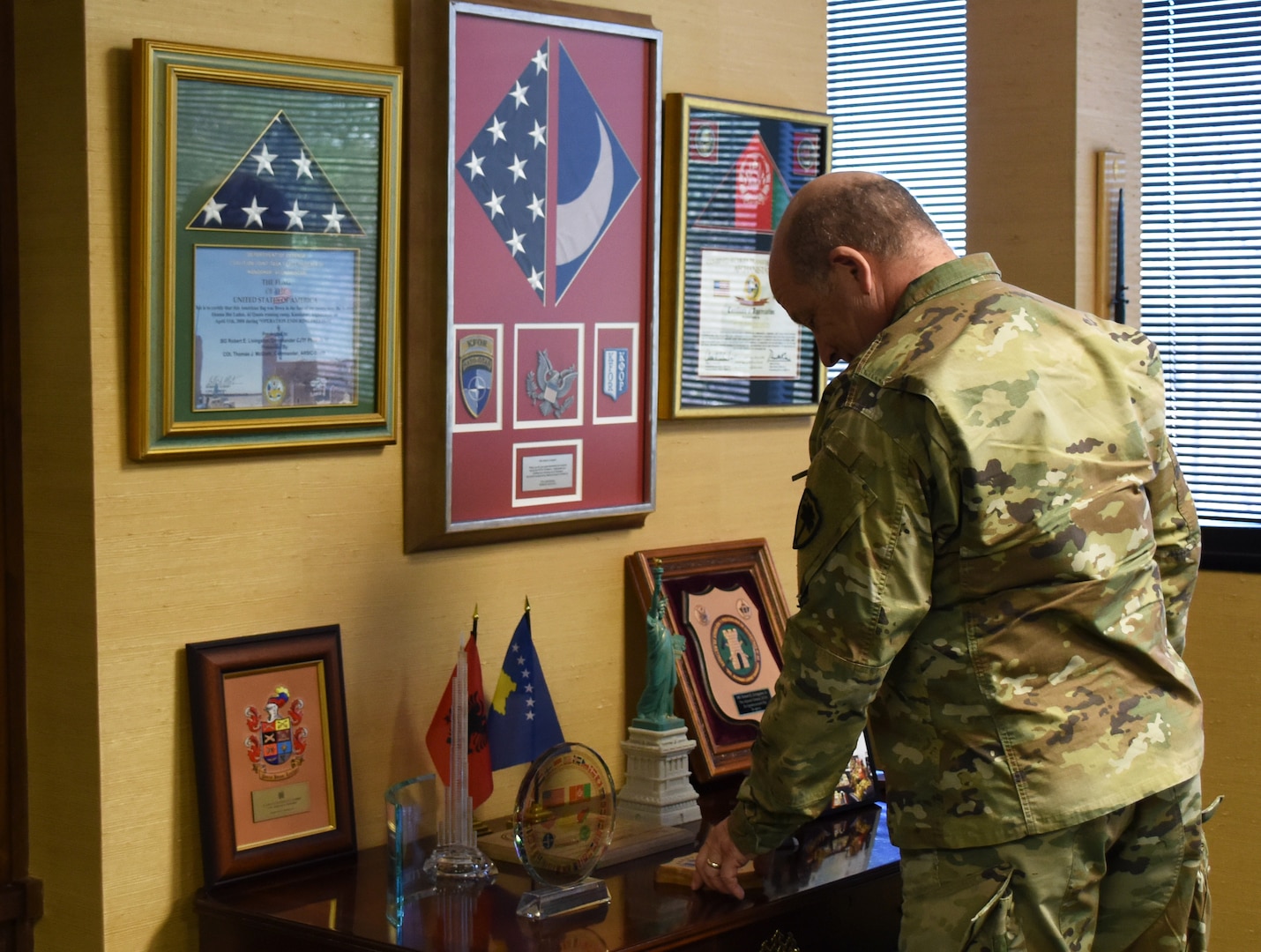 U.S. Army Maj. Gen. Robert E. Livingston, Jr., the adjutant general for South Carolina, looks over memorabilia and plaques in his office at the South Carolina Military Department headquarters in Columbia, South Carolina, Jan. 24, 2019.