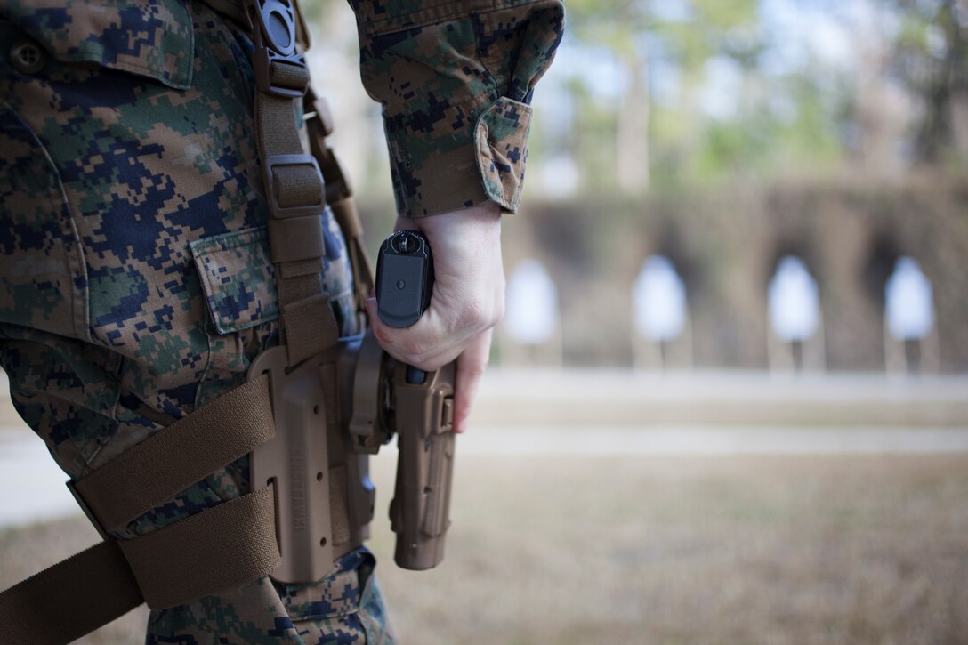 A Marine with Marine Forces Reserve draws a Beretta M9 service pistol during the Combat Pistol Program, at Camp Villere, La., Jan. 24, 2019.