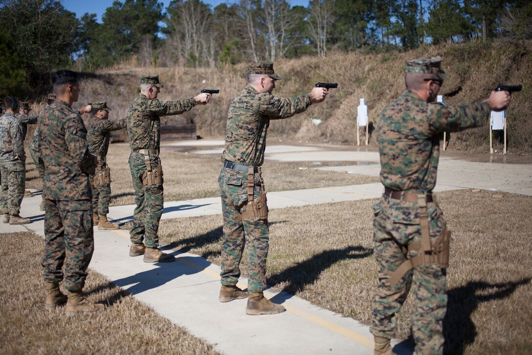 Marines with Marine Forces Reserve prepare to fire during the Combat Pistol Program, at Camp Villere, La., Jan. 24, 2019.