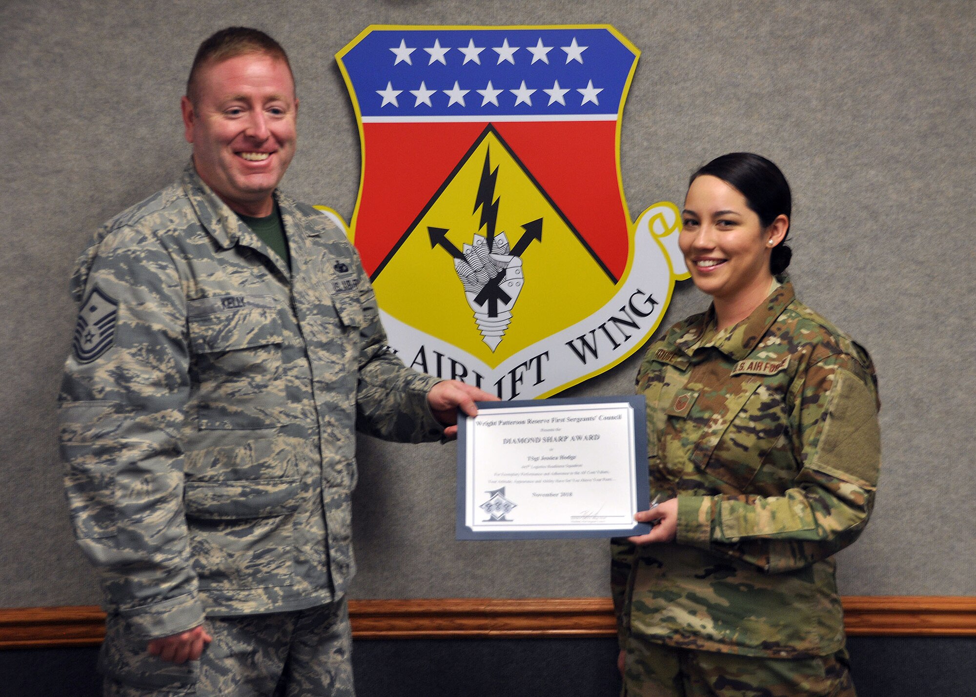 Master Sgt. Kevin Kelly, 445th Aerospace Medicine Squadron first sergeant, presents the November 2018 Diamond Sharp Award to Master Sgt. Jessica Hodge, 445th Logistics Readiness Squadron logistics planner, during the January 5, 2019 unit training assembly. The award is for exemplary performance, adherence to the Air Force Core Values, attitude, appearance and ability.