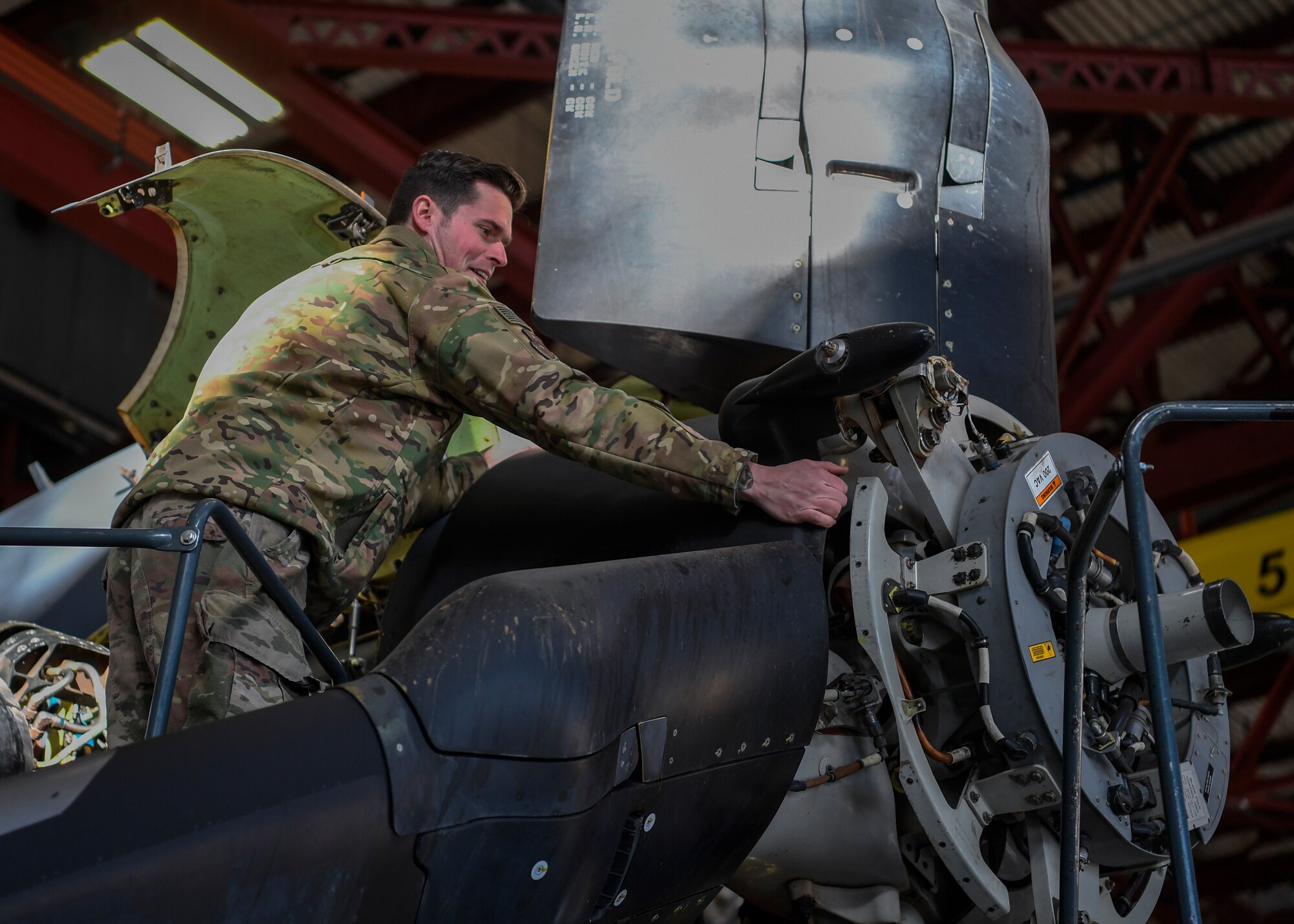Airmen perform maintenance on aircraft.