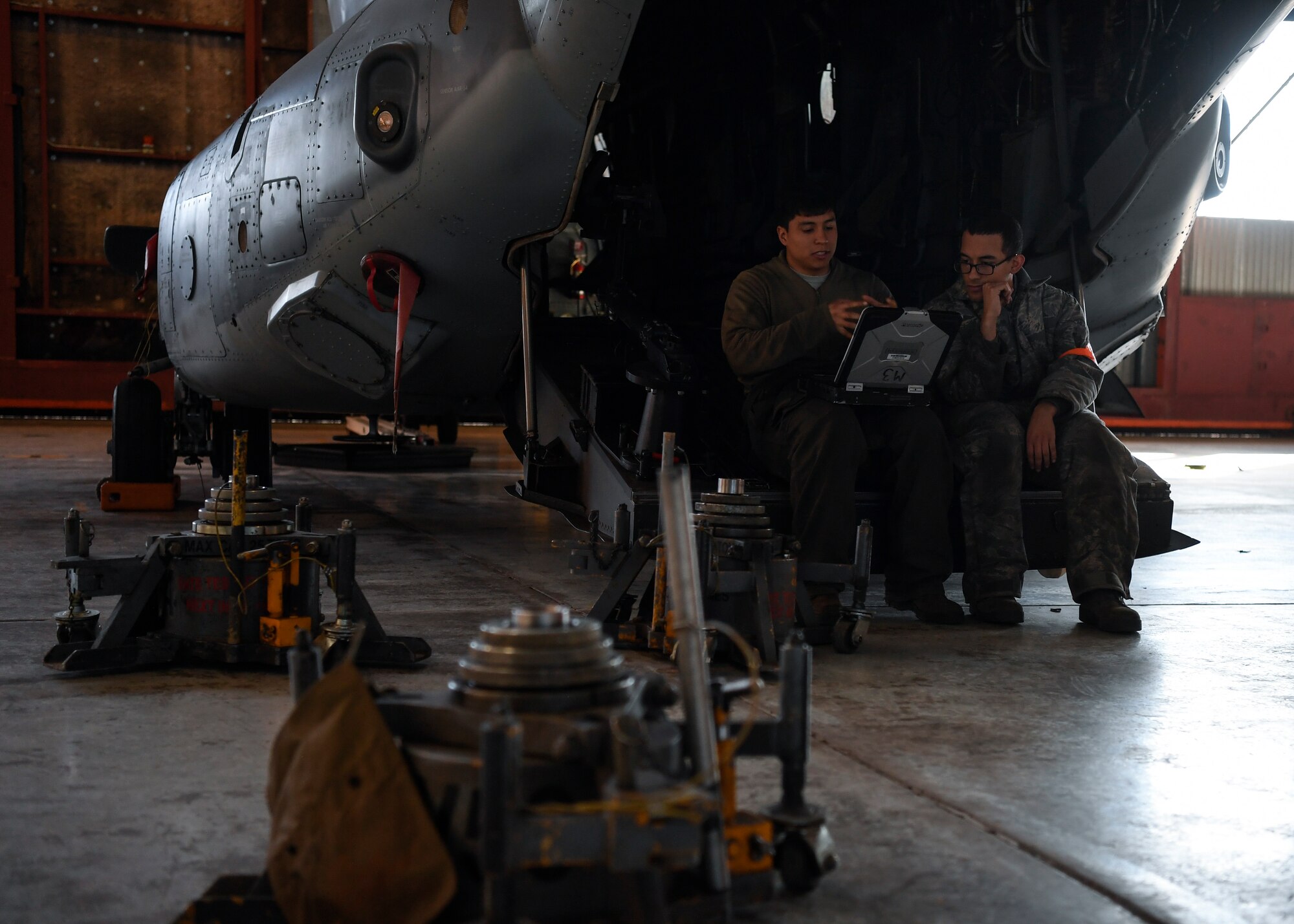 Airmen sitting in back of CV-22 Ospey.