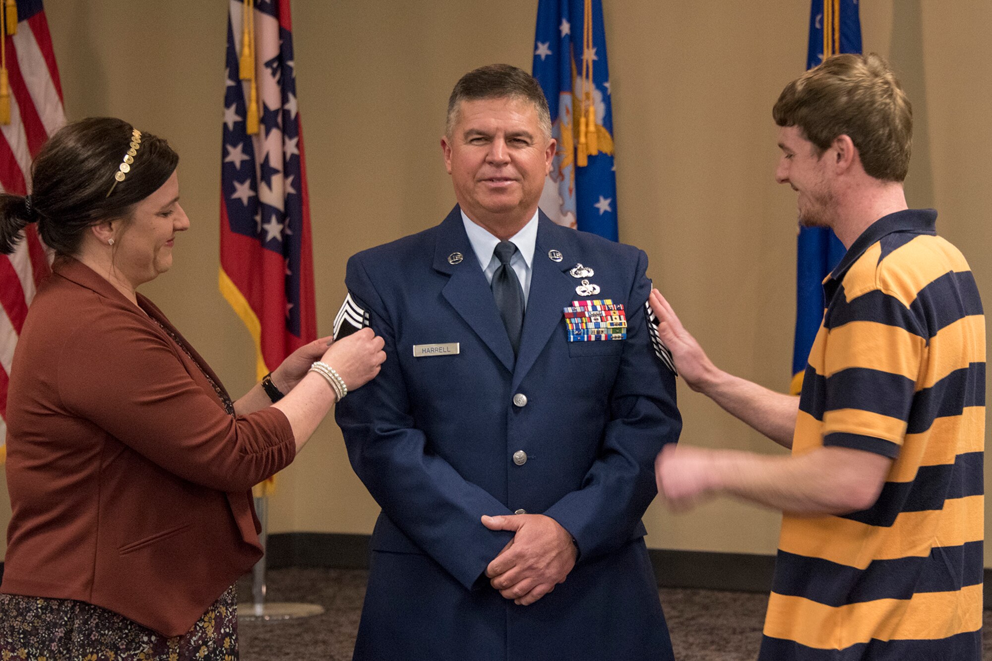 Chief Master Sgt. Nathan E. Harrell, 288th Operations Support Squadron superintendent, has his stripes pinned on by family members during his promotion ceremony at Ebbing Air National Guard Base, Fort Smith, Ark., Feb. 2, 2019. Harrell has over 36 years of military service, and has been a member of the 188th Wing since 1985. (U.S. Air National Guard photo by Staff Sgt. Emmanuel Gutierrez)