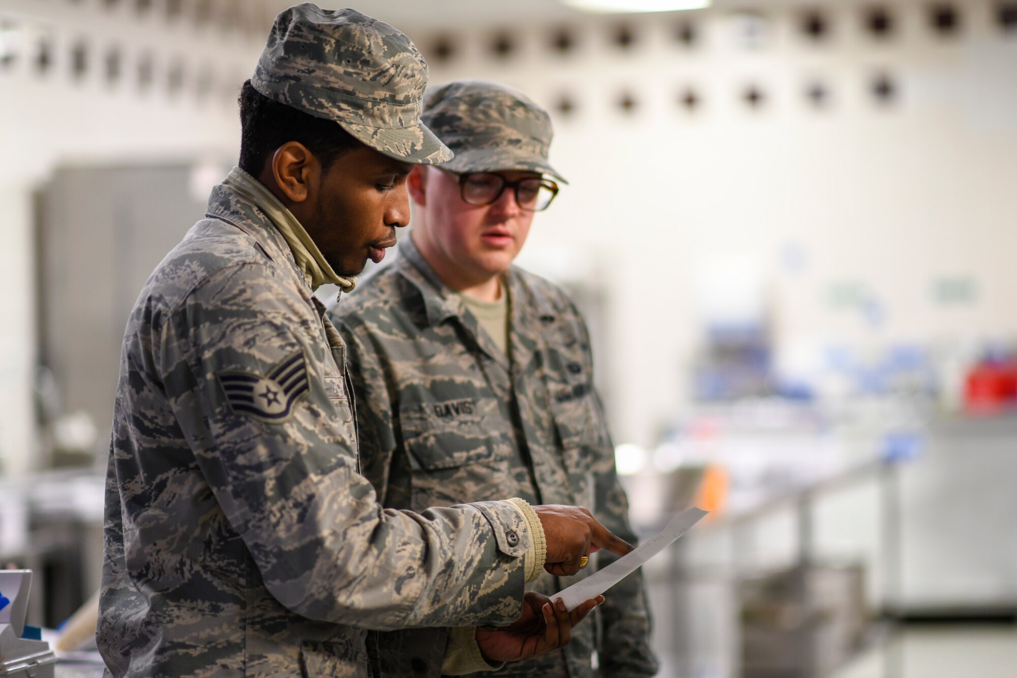 Chefs assigned to the 48th Force Support Squadron review a recipe for dinner at the Knight’s Table dining facility on Royal Air Force Lakenheath, England, Jan. 31, 2019. The facility offers a main dish with three entrees to choose from, as well as a snack line that provides a variety of additional meal items. (U.S. Air Force photo by Senior Airman Malcolm Mayfield)