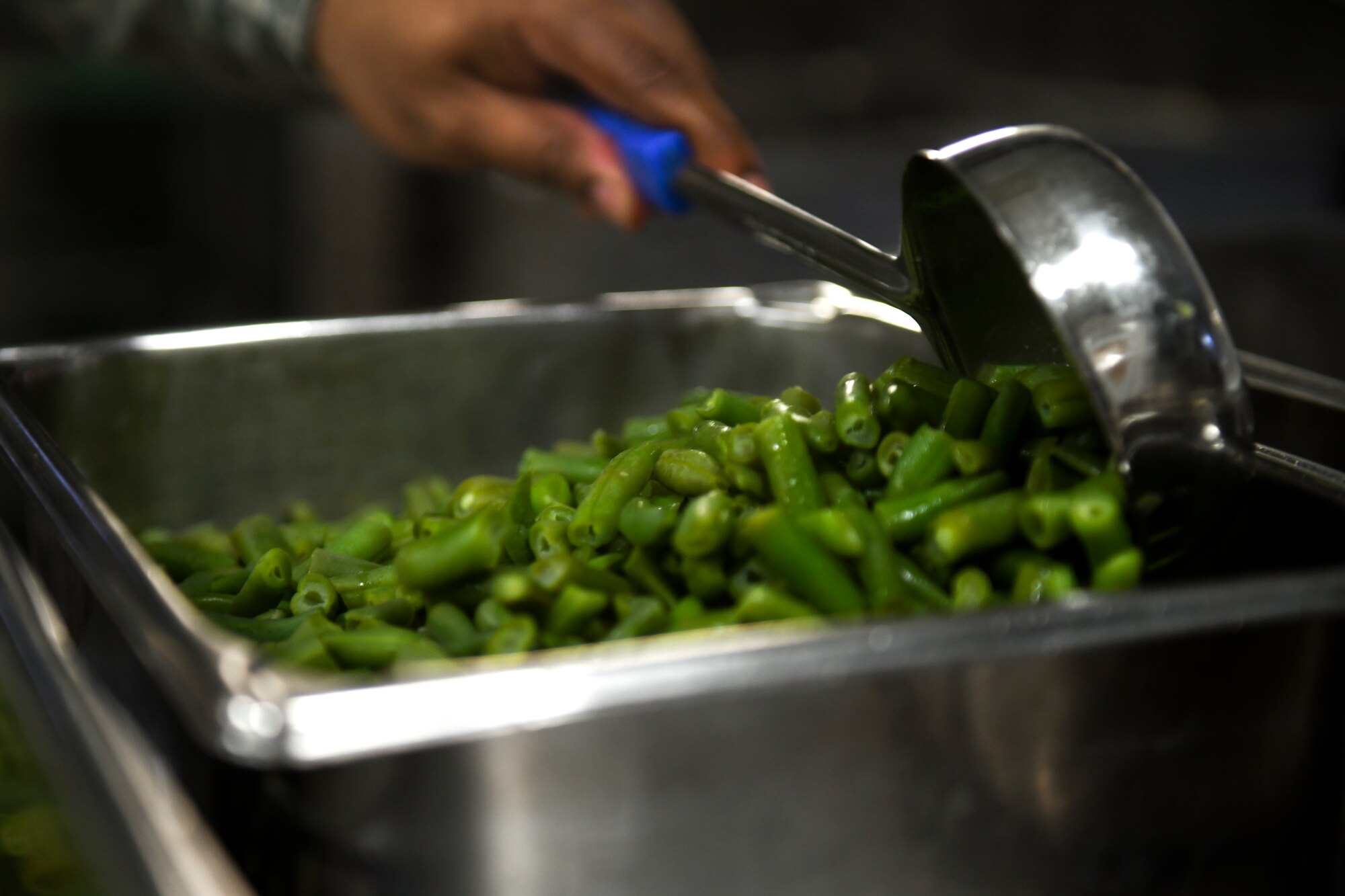 A chef assigned to the 48th Force Support Squadron prepares a serving container full of vegetables for dinner at the Knight’s Table dining facility on Royal Air Force Lakenheath, England, Jan. 31, 2019. The Knight’s Table provides four meals daily Monday through Friday, and two meals on weekends and holidays. (U.S. Air Force photo by Senior Airman Malcolm Mayfield)