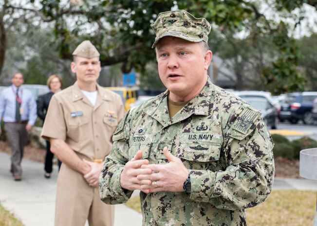 Naval Surface Warfare Center Panama City Division Commanding Officer Capt. Aaron Peters administers the oath of office to 10 newly hired federal civil service employees at the flagpole Feb. 4, 2019. U.S. Navy photos by Eddie Green