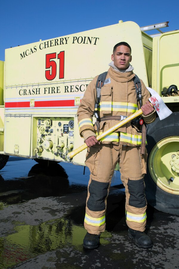 U.S. Marine Corps Lance Cpl. Christopher A. Sims, an aircraft rescue and firefighting specialist, stands next to a crash fire rescue truck at Marine Corps Air Station Cherry Point, North Carolina, Dec. 11, 2018. While being in the Marine Corps, Sims has learned a lot that will help him be a better Marine and one day, a better civilian. Some of those things include respect towards other people, regardless of rank, and how to be a better leader. Sims, 20, from Meadow Bridge, West Virginia, is assigned to Marine Wing Support Squadron 274, Marine Wing Support Group 27, 2nd Marine Aircraft Wing. (U.S. Marine Corps photo by Lance Cpl. Andrew King)