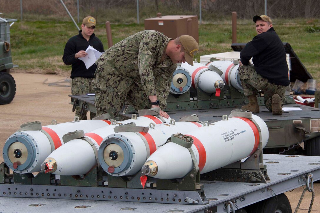 Sailors from Joint Base Charleston, South Carolina prepare inert marine mines at Barksdale Air Force Base, Louisiana, Jan. 31, 2019.   The mines will be laid by a B-52 Stratofortress.  The cross-service effort occurs on a biannual basis.  (U.S. Air Force photo by Master Sgt. Ted Daigle)