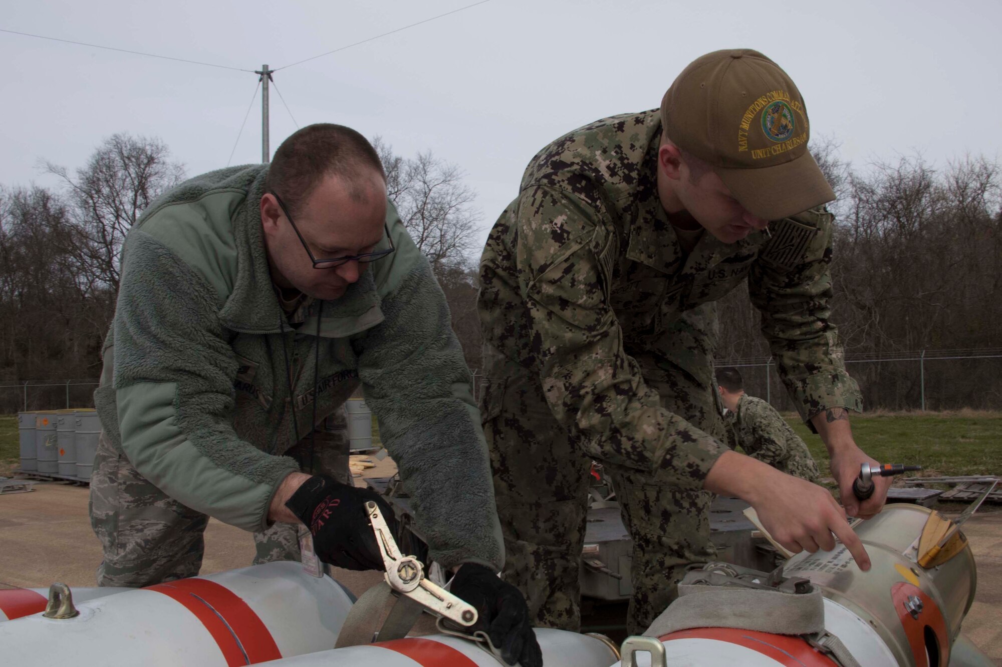Airmen and Sailors worked side by side to ready inert underwater mines for loading aboard a B-52 Stratofortress at Barksdale Air Force Base, Louisiana, Jan. 30, 2019.   The joint service effort strengthens capabilities between the Air Force and Navy and highlights the B-52’s maritime capabilities. (U.S. Air Force photo by Master Sgt. Ted Daigle)