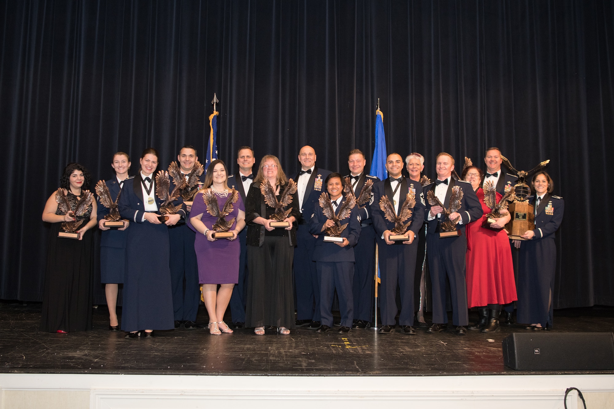 Annual award winners pose with 436th Airlift Wing commander Col. Joel Safranek and command chief Chief Master Sgt. Anthony Green at the conclusion of the 2018 Annual Awards Ceremony Feb. 1, 2019, at the Rollins Center in Dover Downs Hotel and Casino, Dover, Delaware. 13 individuals and one team were recognized as the best in the wing and received the coveted eagle trophies for their respective categories. (U.S. Air Force photo by Mauricio Campino)