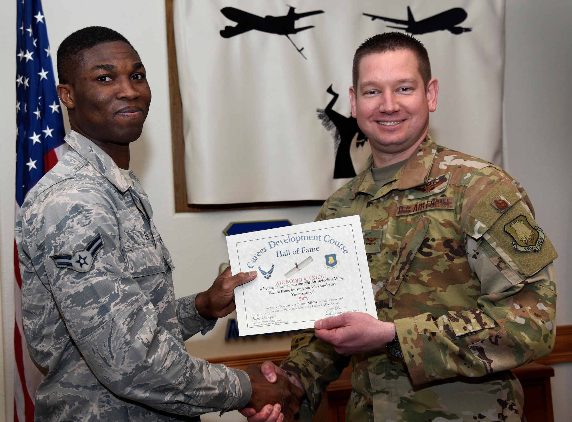 Airman 1st Class Kodjo Eklou, 22nd Logistics Readiness Squadron flight service center apprentice, is recognized by Col. Mark Baran, 22nd Air Refueling Wing vice commander, for earning a score of 98 percent on his Career Development Course Feb. 5, 2019, at McConnell Air Force Base, Kan. CDCs help enlisted personnel complete the specialty knowledge portion of on-the-job training for their specific career fields.