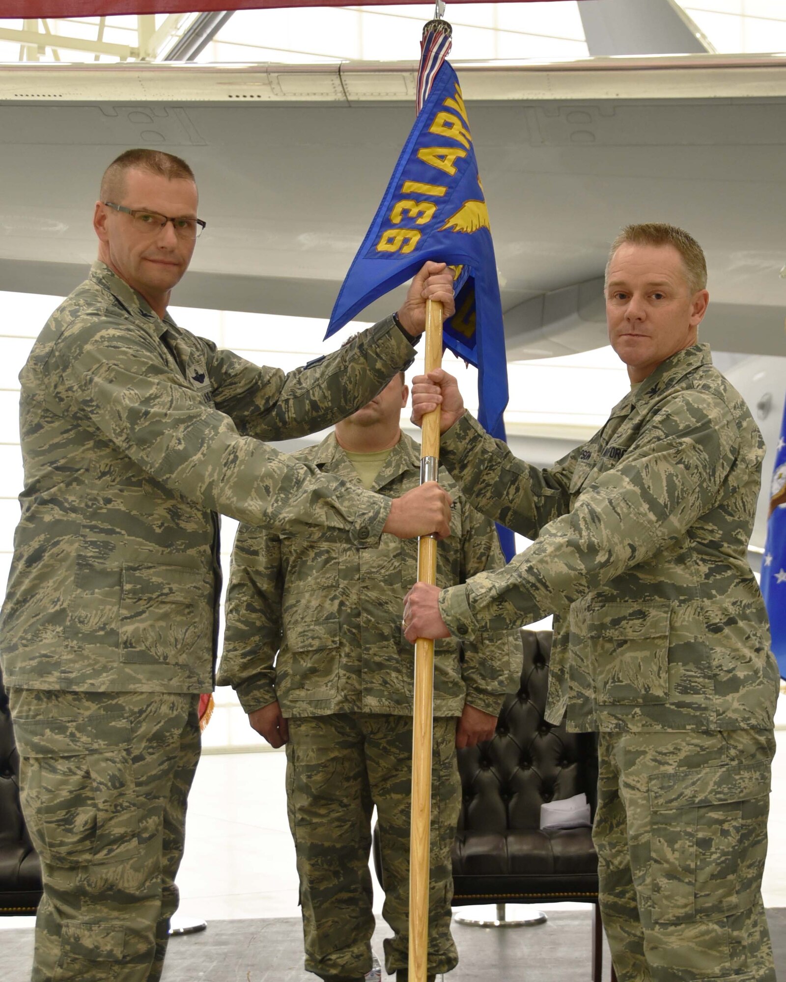 (Left to right) Col. Phil Heseltine, 931st Air Refueling Wing commander, hands the guidon to Col. Robert Thompson, the incoming 931st Maintenance Group commander, during an official change of command ceremony, Feb. 3, 2019, McConnell Air Force Base, Kan. As commander of the 931 MXG, Thompson is directly responsible for the training and readiness of more than 270 Reserve Citizen Airmen.