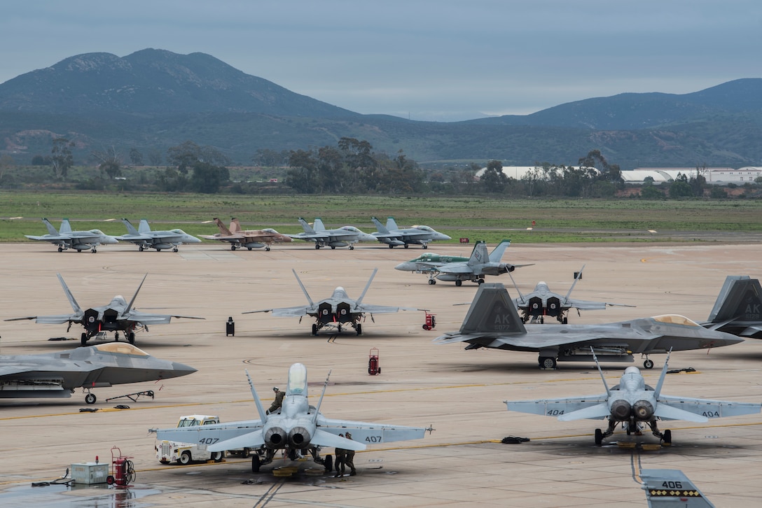 Various aircraft stay positioned on the flightline during joint exercise Winter Fury at Marine Corps Air Station Miramar, San Diego, Calif., Jan. 17, 2019. Winter Fury involved both Marine F/A-18C Hornets, and Navy F-35C Lightning II’s, partnering with Air Force F-22 Raptors to perform air-to-air combat, while protecting ground assets.