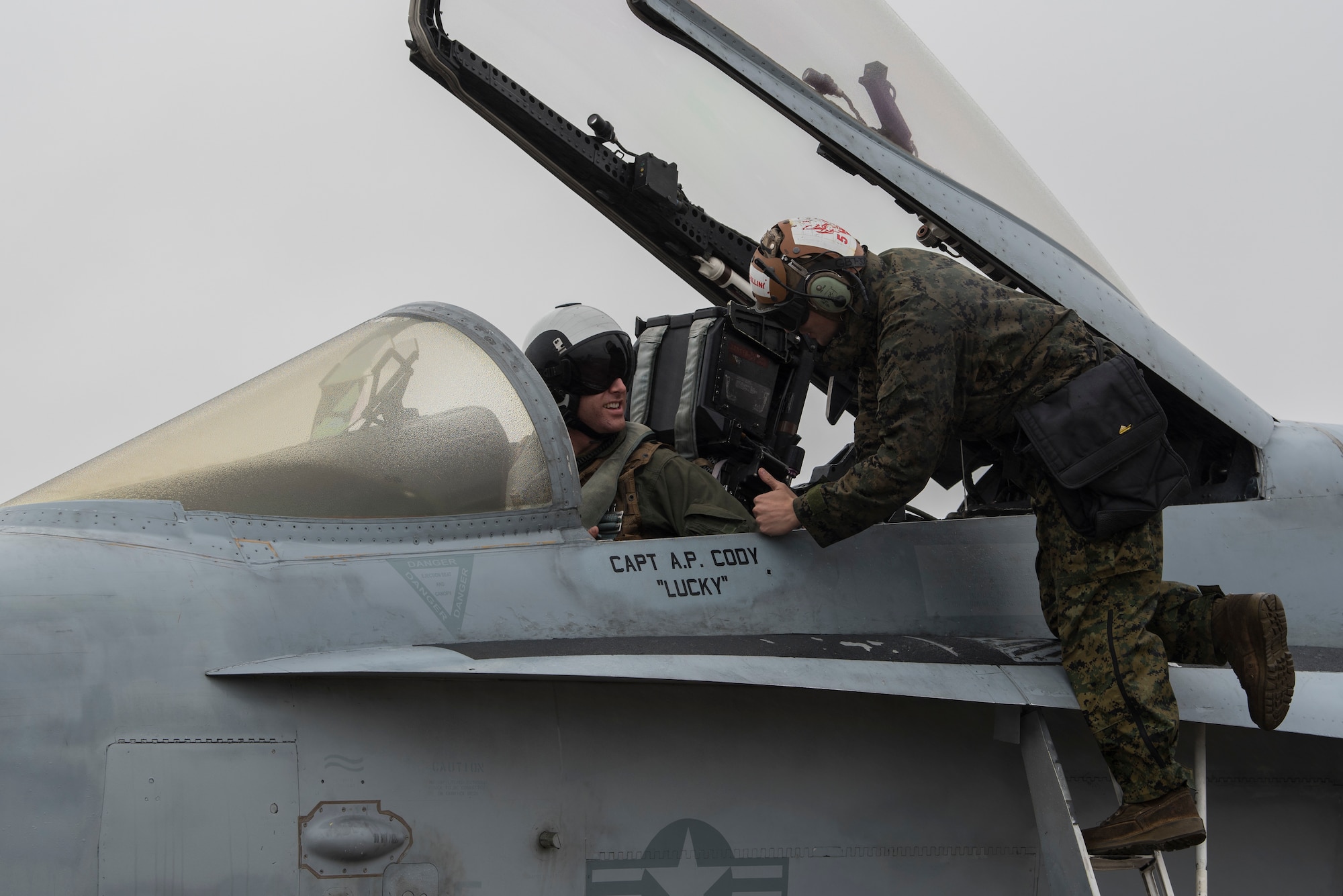 A U.S. Marine Corps F/A-18C Hornet pilot and crew chief talk before takeoff during joint exercise Winter Fury at Marine Corps Air Station Miramar, San Diego, Calif., Jan 17, 2019. Winter Fury involved both Marine F/A-18C Hornets, and Navy F-35C Lightning II’s, partnering with Air Force F-22 Raptors to perform air-to-air combat, while protecting ground assets.