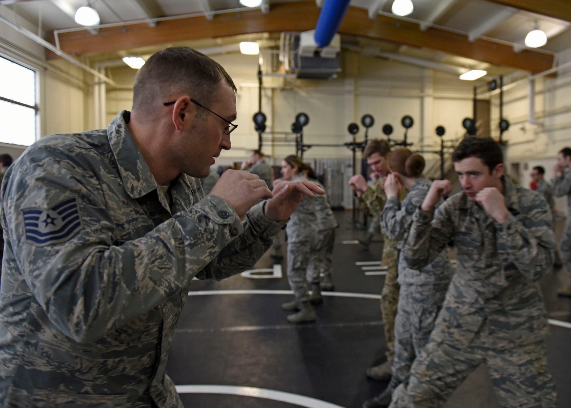 U.S. Air Force Tech. Sgt. Jarad Underwood, 22nd Training Squadron Advanced Skills Training NCO in charge, does one-on-one training with an Airman during combat survival training for aircrew and battlefield Airmen at Fairchild Air Force Base, Washington, Jan. 31, 2019. The combatives class teaches projectile striking, clenching and grappling self-defense techniques to prepare Airmen for any emergency event or captivity situation. (U.S. Air Force photo/Senior Airman Jesenia Landaverde)