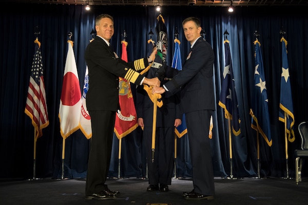 U.S. Navy Adm. Philip S. Davidson, commander, U.S. Indo-Pacific Command, passes the United States Forces Japan guidon to the new U.S. Forces Japan commander. U.S. Air Force Lt. Gen. Kevin B. Schneider, during the change of command ceremony at Yokota Air Base, Japan, Feb. 5, 2019. Schneider previously served as the chief of staff, United States Indo-Pacific Command. (U.S. Air Force photo by Senior Airman Donald Hudson)