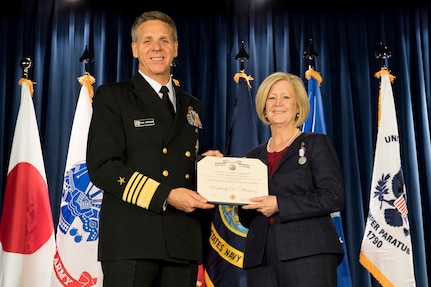 U.S. Navy Adm. Philip S. Davidson, U.S. Indo-Pacific Command commander, shakes hands with Mrs. Kim Martinez, Lt. Gen. Jerry P. Martinez’s spouse, after presenting her with the Outstanding Public Service Award during the United States Forces Japan and 5th Air Force change of command ceremony at Yokota Air Base, Japan, Feb. 5, 2019. During the ceremony, U.S. Air Force Lt. Gen. Kevin B. Schneider assumed command of USFJ and 5th AF from U.S. Air Force Lt. Gen. Jerry P. Martinez. (U.S. Air Force photo by Senior Airman Donald Hudson)