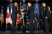 U.S. Air Force Lt. Gen. Jerry P. Martinez, (right), relinquishes command of 5th Air Force and passes the guidon to U.S. Air Force Gen. CQ Brown, Jr., commander, Pacific Air Forces (left), during the United States Forces Japan and 5th AF change of command ceremony at Yokota Air Base, Japan, Feb. 5, 2019. The passing of the guidon marks the end of Martinez’s tour as the commander of the USFJ. (U.S. Air Force photo by Senior Airman Donald Hudson)