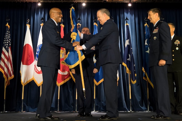 U.S. Air Force Lt. Gen. Jerry P. Martinez, (right), relinquishes command of 5th Air Force and passes the guidon to U.S. Air Force Gen. CQ Brown, Jr., commander, Pacific Air Forces (left), during the United States Forces Japan and 5th AF change of command ceremony at Yokota Air Base, Japan, Feb. 5, 2019. The passing of the guidon marks the end of Martinez’s tour as the commander of the USFJ. (U.S. Air Force photo by Senior Airman Donald Hudson)