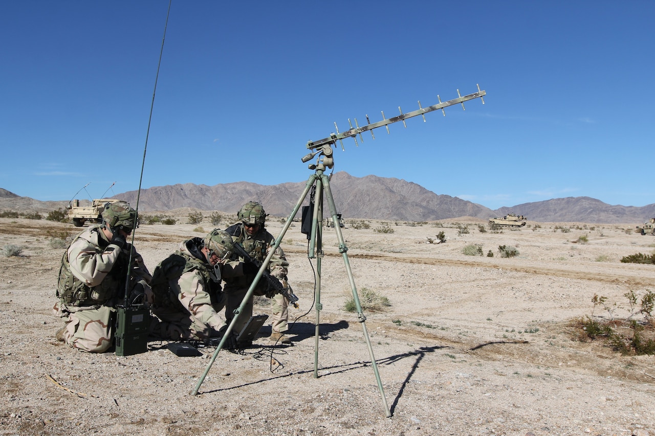 Soldiers set up cyberspace equipment.