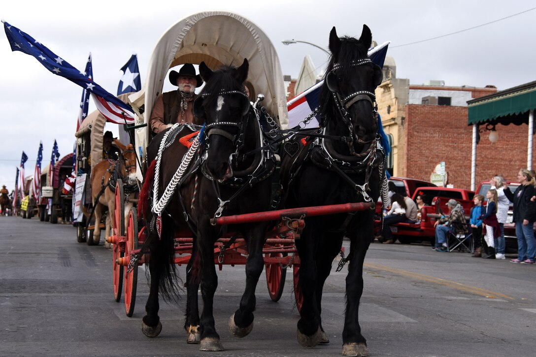 Old Fort Concho representatives lead the parade with horses, mules and buggies during the 87th annual San Angelo Stock Show and Rodeo Parade in downtown San Angelo Feb. 2, 2019. The parade kicked off the rodeo this year which will be taking place from Feb. 2-17, 2019. (U.S. Air Force photo by Senior Airman Seraiah Hines/Released)
