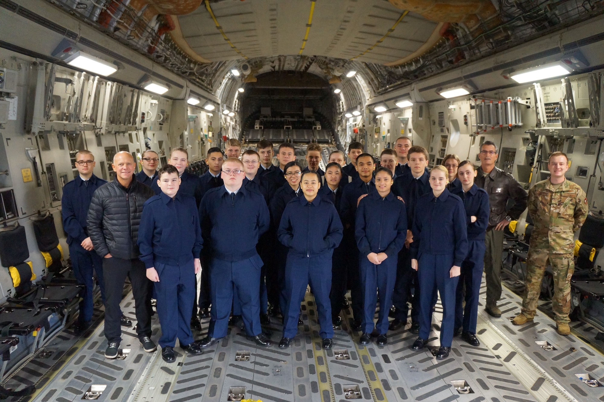 Bethel High School JROTC cadets pause for a group photo with Staff Sgt. Zack Epperson, 313th Airlift Squadron loadmaster, and former Bethel HS JROTC cadet, at McChord Field, Wash. The cadets got to experience an orientation flight on a C-17 Globemaster III in January. (Courtesy photo)