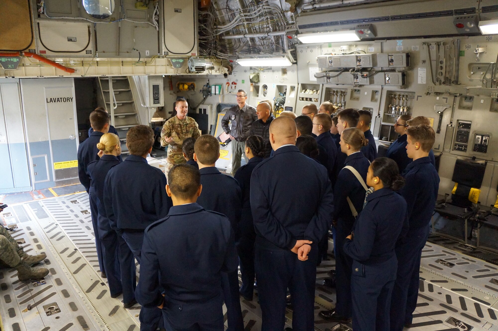 Staff Sgt. Zack Epperson, 313th Airlift Squadron loadmaster, gives a safety briefing to Bethel High School JROTC cadets prior to their recent orientation flight on McChord Field in January. (Courtesy photo)