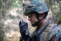 Sgt. Moises Labra conducts a radio check during a land navigation course Jan. 29, 2019 at Jungle Warfare Training Center, Camp Gonsalves, Okinawa, Japan. The Jungle Warfare Training Center teaches Marines survival skills needed for the jungle, as well as build unit cohesion and small unit leadership. Labra is a motor transportation operator with Motor Transportation Company, 3rd Transportation Battalion, Combat Logistics Regiment 3, 3rd Marine Logistics Group. Labra is a native of San Diego, California. (U.S. Marine Corps photo by Lance Cpl. Terry Wong)