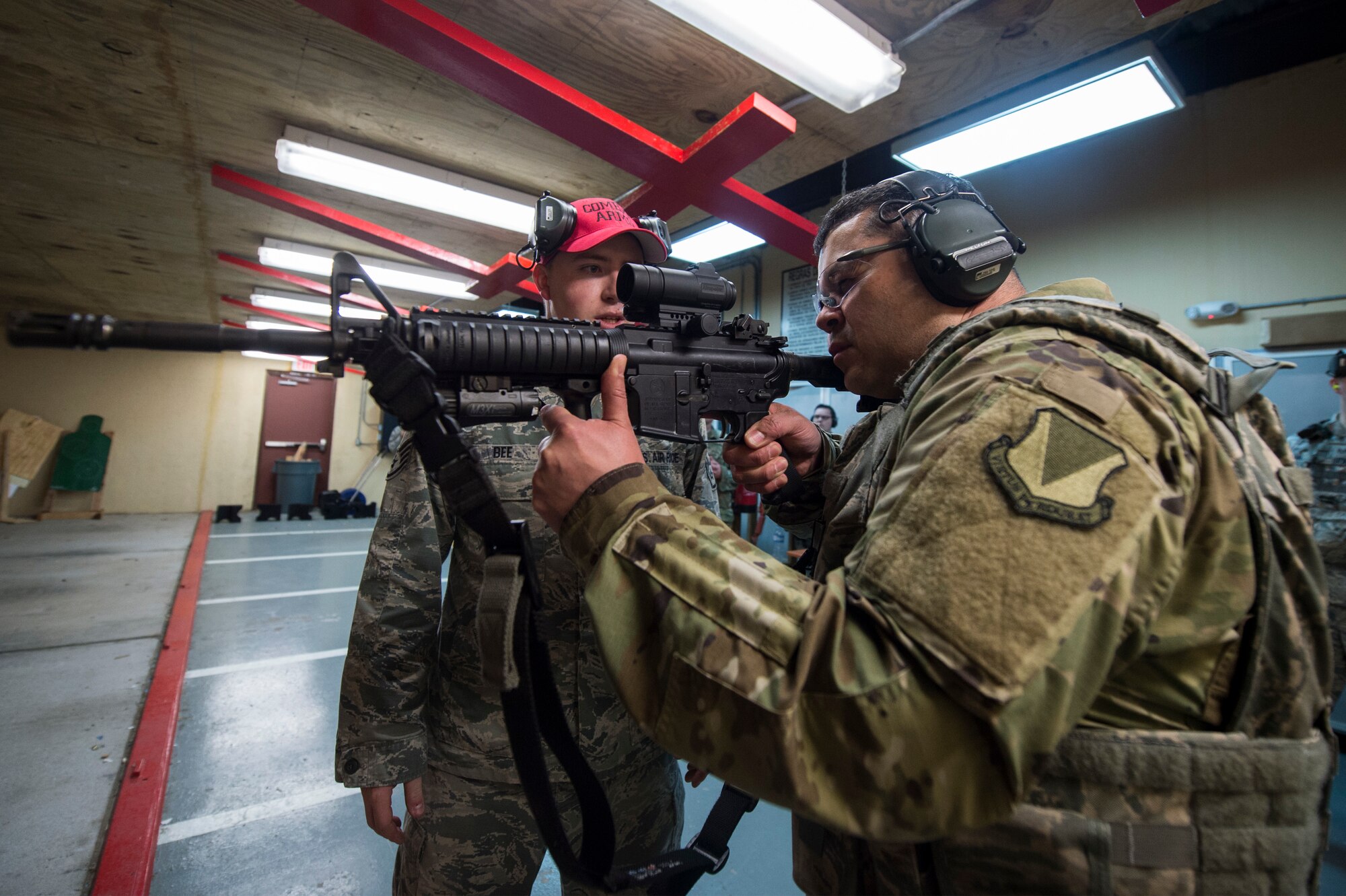 U.S. Air Force Chief Master Sgt. Ernesto Rendon, 86th Airlift Wing command chief, prepares to fire an M-4 Carbine during a training session inside the 65th Security Forces Squadron’s Combat Arms Training and Maintenance building at Lajes Air Field, Azores, Jan. 30, 2019. The scenario had Rendon fire at three targets at increasing distance, while utlizing 10 rounds and attempting to put two rounds on each target. (U.S Air Force photo by Staff Sgt. Jonathan Bass)